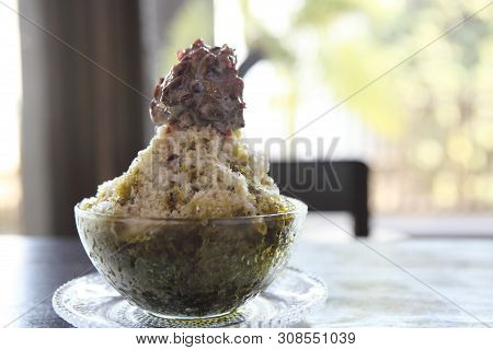 Traditional Japanese Dessert , A Bowl Of Red Bean Sweet With Red Ice On Wood Pattern