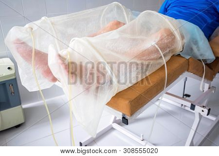 Ozone Therapy Treatment On Legs Of Man