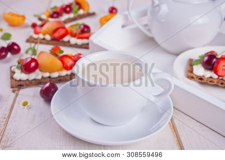 Cup Of Tea And Crisp Bread With Creme Cheese, Fruit And Berries