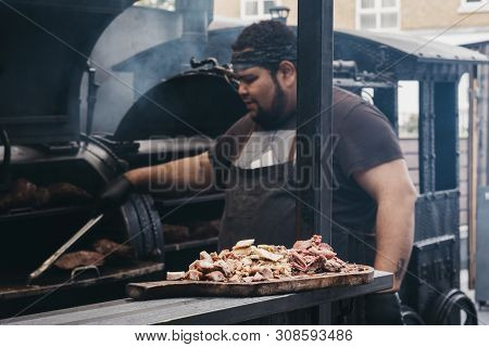 London, Uk - June 22,2019:meat Samples At A Smokoloco Stall, Staff Cooking On The Background Inside 