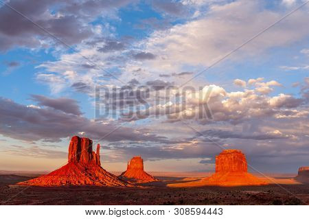 The Famous Merrick And Mittens Buttes From Monument Valley Basking In The Light Of The Setting Sun.