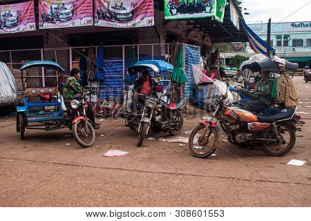 Pakse, Laos - Sep 12: Tuk Tuk Drivers At A Market In Pakse, Laos On Sep 12, 2013. Pakse Is The Third