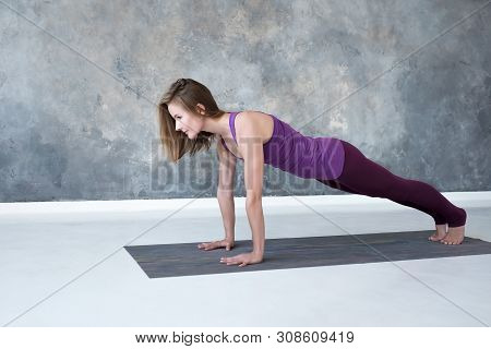 Woman Practicing Yoga, Doing Push Ups Or Press Ups Exercise, Phalankasana, Plank Pose