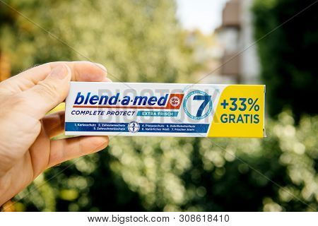 Berlin, Germany - Aug 4, 2018: Man Hand Holding Blend-a-med Complete Protect Extra Fresh Toothpaste 