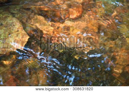 The Clear Water Flows Through The Gravel Are Smooth And Very Cool. Originated From Natural Waterfall