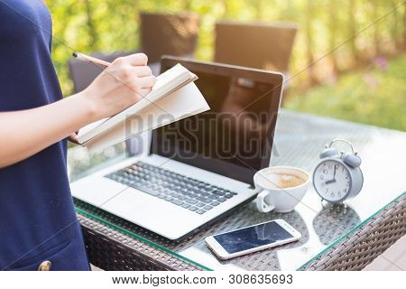 Close-up Of Asian Business Female Working Stand Make A Note With Laptop On Office Outdoor.