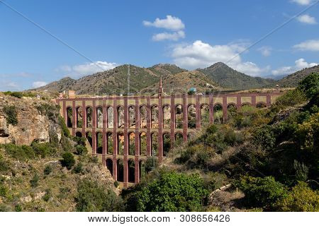 Nerja, Spain - May 30, 2019: View Of The Historical Eagle Aqueduct Close To Nerja
