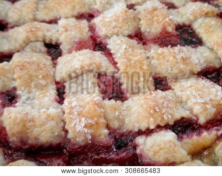 Close-up Of Cherry Pie And Lattice Design With Sugar.