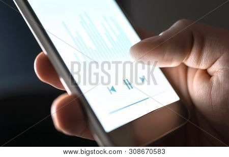 Listening To Podcast, Music Or Audiobook With Mobile Phone. Man Using Streaming Service And Smartpho
