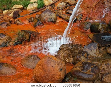 Therapeutic Spring With Mineral Water Narzan Caucasian Ridge. High Concentration Of Iron Gives It Ru