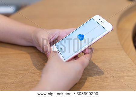 Chiang Mai, Thailand - May.10,2019: Woman Holding Apple Iphone 6s Rose Gold With Onedrive On Screen.