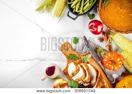 Thanksgiving Holiday Table With Traditional Festive Food - Turkey, Pumpkin Pie, Pumpkins, Green Bean