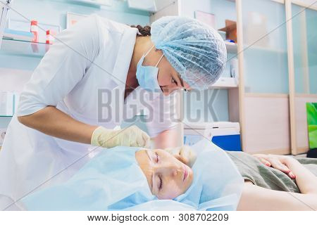 Aged Woman Doing Mesothreads And Thread Lifting, Cosmetology. Cosmetic Procedure To Eliminate Signs 
