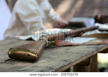 Old Rifle On A Wooden Table Gunsmith. Reconstruction Of Weapon Of The 19th Century