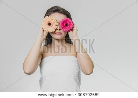 Young Beautiful Girl With Two Flowers. Flowers Have Differrent Colors.