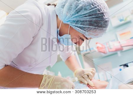 Aged Woman Doing Mesothreads And Thread Lifting, Cosmetology. Cosmetic Procedure To Eliminate Signs 