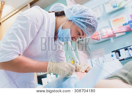 Aged Woman Doing Mesothreads And Thread Lifting, Cosmetology. Cosmetic Procedure To Eliminate Signs 