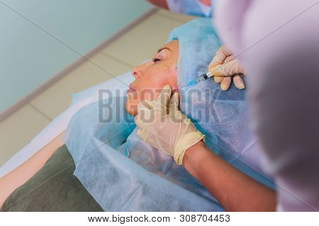 Aged Woman Doing Mesothreads And Thread Lifting, Cosmetology. Cosmetic Procedure To Eliminate Signs 