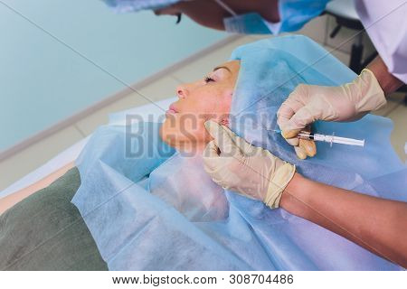 Aged Woman Doing Mesothreads And Thread Lifting, Cosmetology. Cosmetic Procedure To Eliminate Signs 