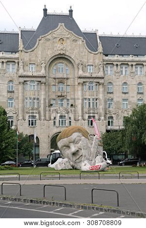 Budapest, Hungary - July 13, 2015: Giant Sculpture Poked His Head And Fingers A Sculpture Named Repo