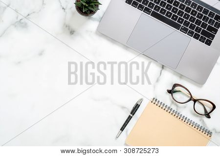 Marble Office Desk Table With Laptop Computer, Paper Notepad, Glasses, Succulent Plant, Stationery. 