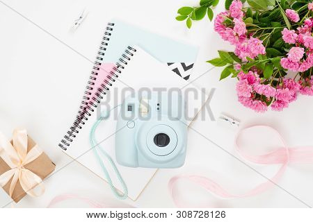 Feminine Home Office Desk With Modern Instant Film Camera,paper Notebook And Notepad, Bouquet Of Pik