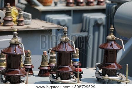 Detail Of A High Voltage Electrical Transformer With Connectors To Connect Three-phase Cables To The