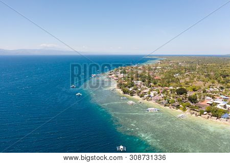 Coast Of Cebu Island, Moalboal, Philippines, Top View. Philippine Boats In A Blue Lagoon Over Coral 