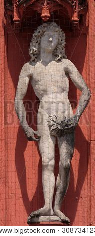 WURZBURG, GERMANY - JULY O4, 2018: Statue of Adam on the portal of the Marienkapelle in Wurzburg, Bavaria, Germany