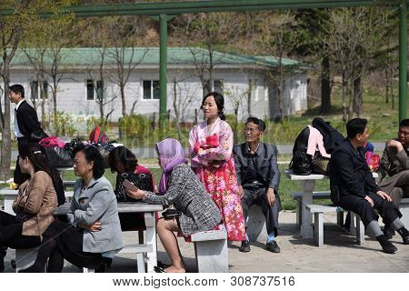 Pyongyang, North Korea - May 1, 2019: People Relaxing In The Taesongsan Funfair. Is An Amusement Par