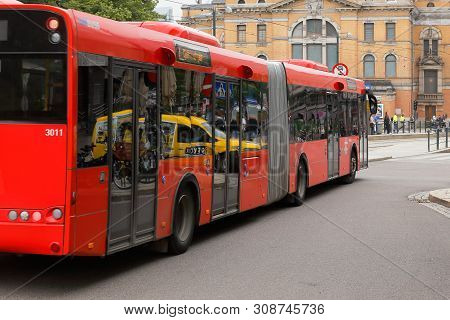 Olso, Norway - June 20, 2019: Rear And Side View Of A Red Colored Articulated Bus In Use For Public 