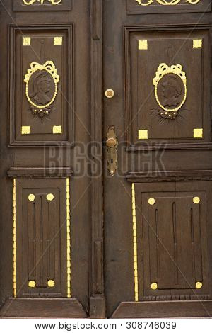 The Gold-studded Old Door Of A Residential Building With Reliefs And Carvings.