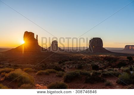 Early Morning Sunrise Over The Famous Merrick En Mittens Butte At Monument Valley, Az.