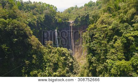 Beautiful Waterfall Coban Sewu In Tropical Forest, Java Indonesia. Aerial View Tumpak Sewu Waterfall