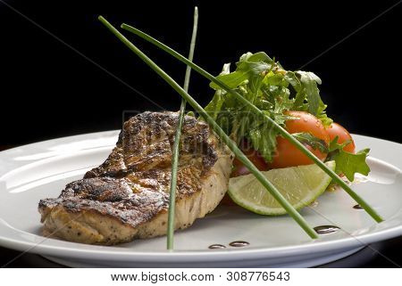 Well-done Steak With Suace And Vagetables. Reastaurant Dishes On The Wooden Table. Food Photo For Re