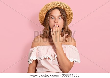 Hirizontal Shot Of Young Woman Wearing Summer Blouse, Sunglasses And Straw Hat, Keeps Hand On Open M