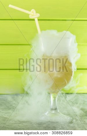 Cocktail With Liquid Nitrogen. Summer Cooling Cocktail In A Glass Glass With A Straw. From Liquid Ni