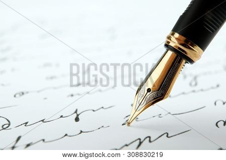 Fountain Pen On Paper With Ink Text On A White Background Closeup