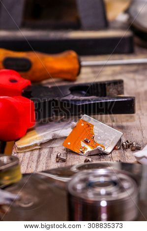 A Man Breaks A Computer Using Locksmith Tools. The Concept Of Hacking, Computer Hacking And Inept Co