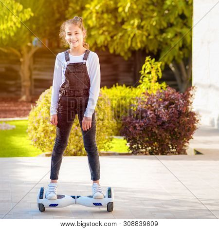 Beautiful Kid Smile With Braces.young Hipster Teenager Girl Balancing On Electric Hover Board, Dual 