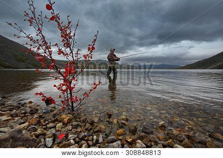 Russia. Far East, Magadan Region. 09/06/2018. Fisherman Spinning Salmon Fishing In The Cold Waters O