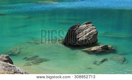 Rock And Turquoise Water Of Lake Cauma.