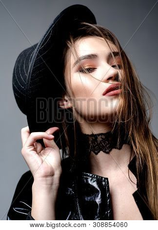 Attractive Woman With Seductive Lips And Gentle Makeup. On Black Background. Headshot Portrait Of Ki