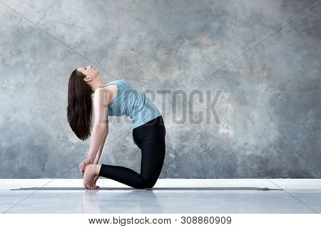 Sporty Beautiful Young Woman Practicing Yoga, Doing Ushtrasana, Camel Pose