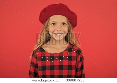 Kid Little Cute Girl Smiling Face Posing In Hat Red Background. Fashionable Beret Accessory For Fema
