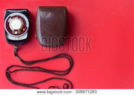 Old Vintage Soviet Exposure Meter With Leather Case On Red Background