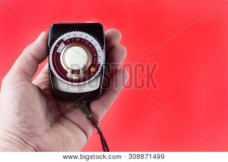 Old Vintage Soviet Exposure Meter With Leather Case On Red Background