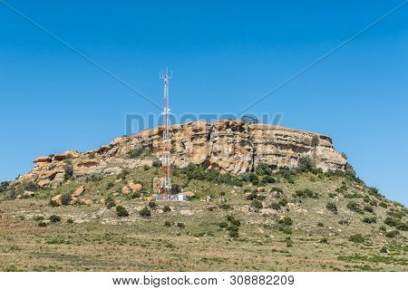 Paul Roux, South Africa, May 1, 2019: A Typical Landscape, With Sandstone Hill And Cell Phone Tower,