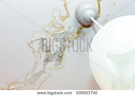Rain Water Leaks On The Ceiling Because Of Damaged Roof Causing Decay, Peeling Paint And Moldy