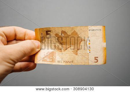 Paris, France - May 19, 2019: Man Hand Holding Against Gray Background 5 Azerbaijani Manat Pepr Curr